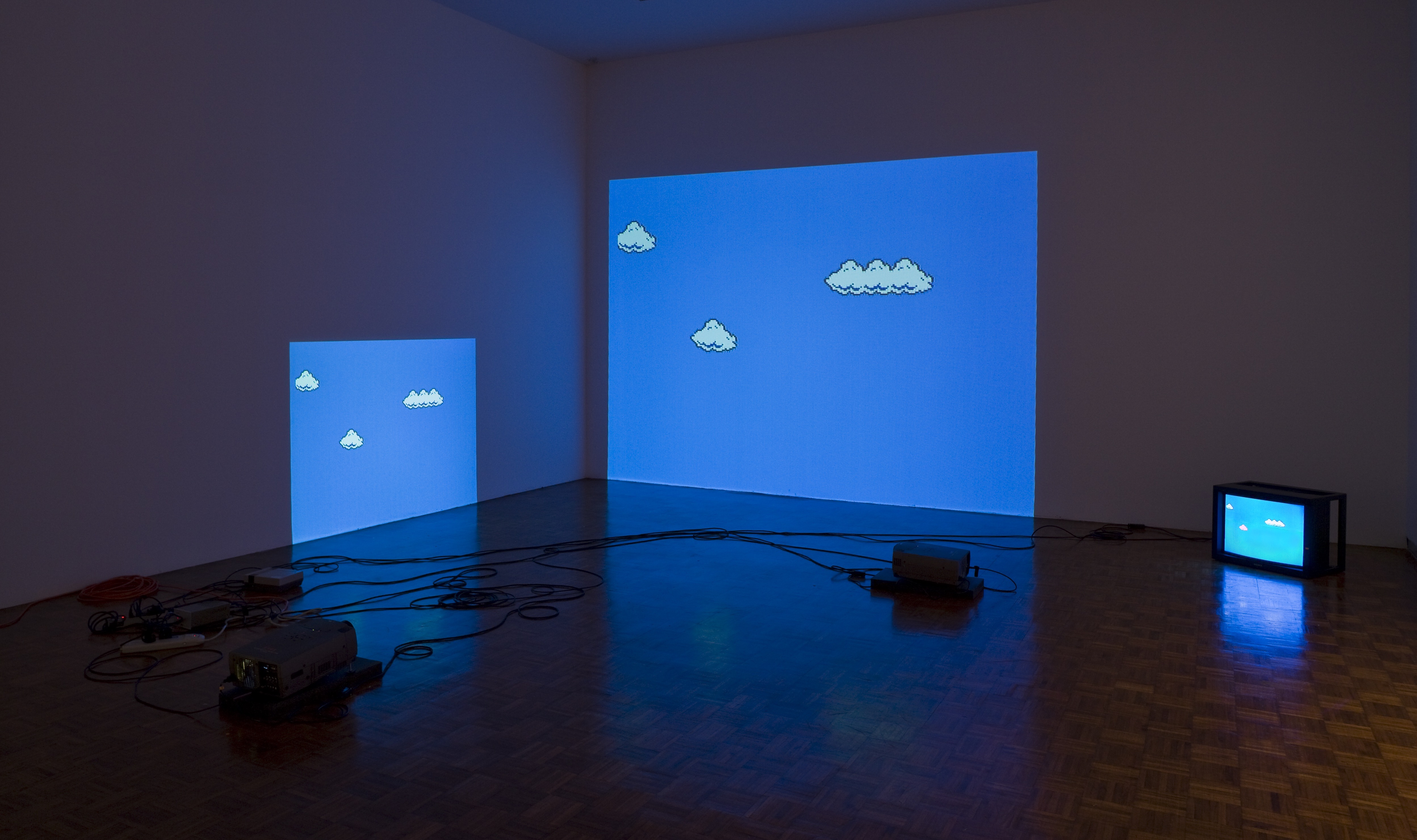 Cory Arcangel. Super Mario Clouds, 2002– . (Installation view, Synthetic, Whitney Museum of American Art, 2009.) Handmade hacked Super Mario Brothers cartridge and Nintendo NES video game system. Edition no. 2/5. Whitney Museum of American Art, New York; purchase with funds from the Painting and Sculpture Committee 2005.10.© Cory Arcangel. Courtesy of Cory Arcangel.